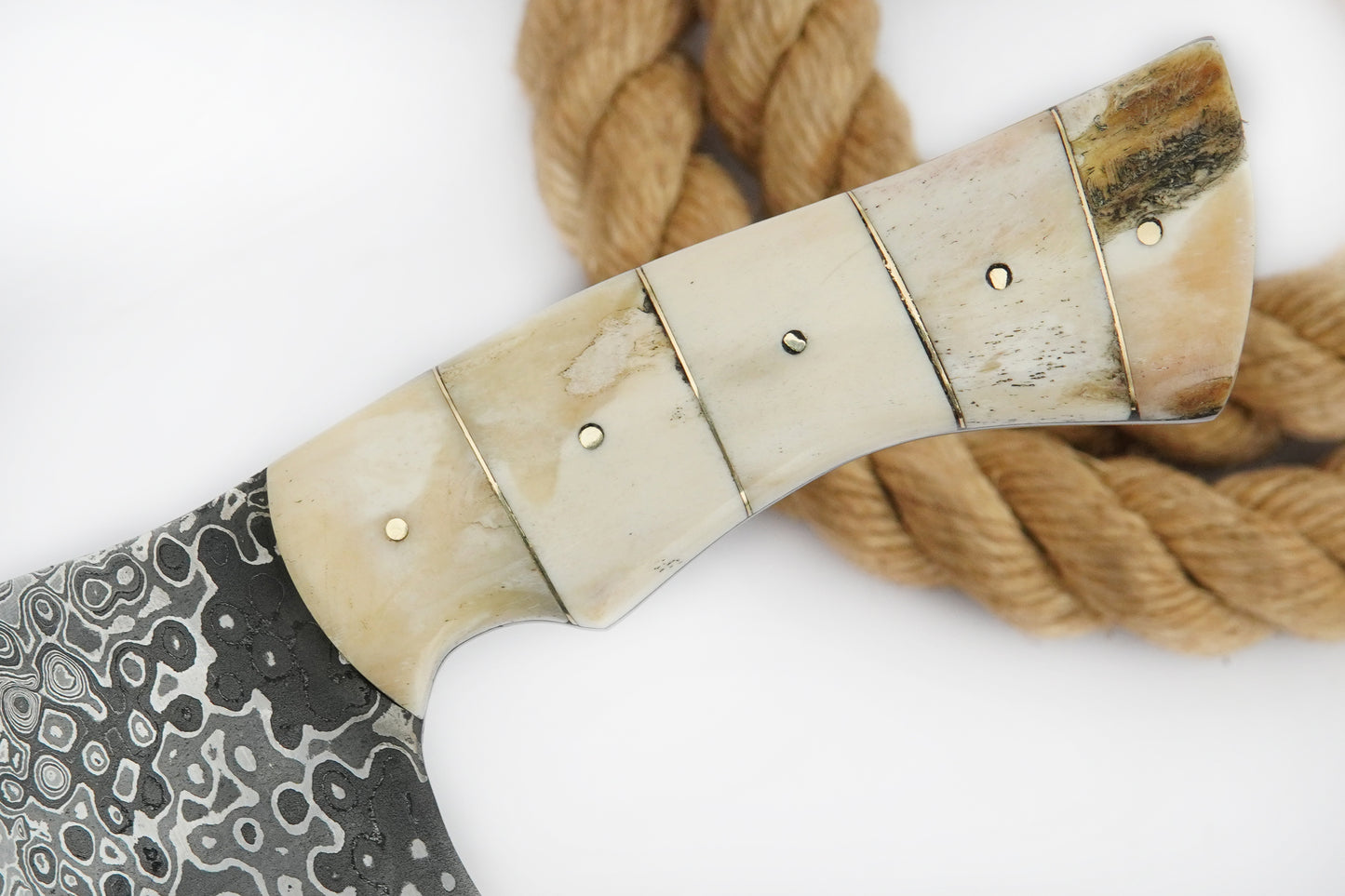 This Serbian chopper knife is forged from layered Damascus steel and finished with a solid natural handle. Strong and practical for daily cooking or outdoor use, the cleaver design handles meat and vegetables with ease. Free engraving is included, so you can make it personal with a name or initials.