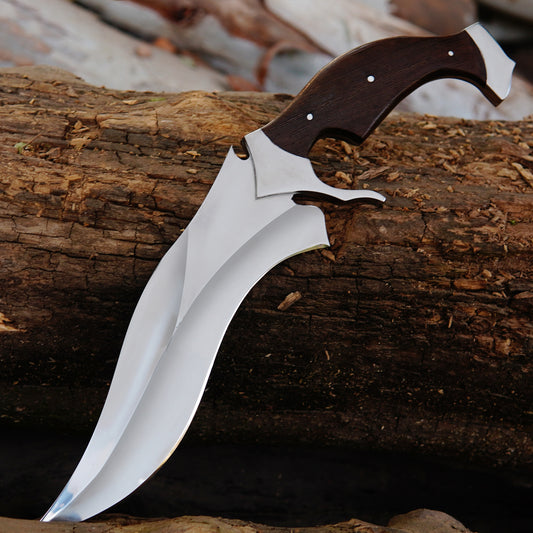Outdoor hunting bowie knife with curved blade and natural material handle placed on wooden logs to create an authentic outdoor environment. The image focuses on blade shape, clean finish, and strong full tang construction while presenting the knife as a practical outdoor companion and handcrafted gift option.