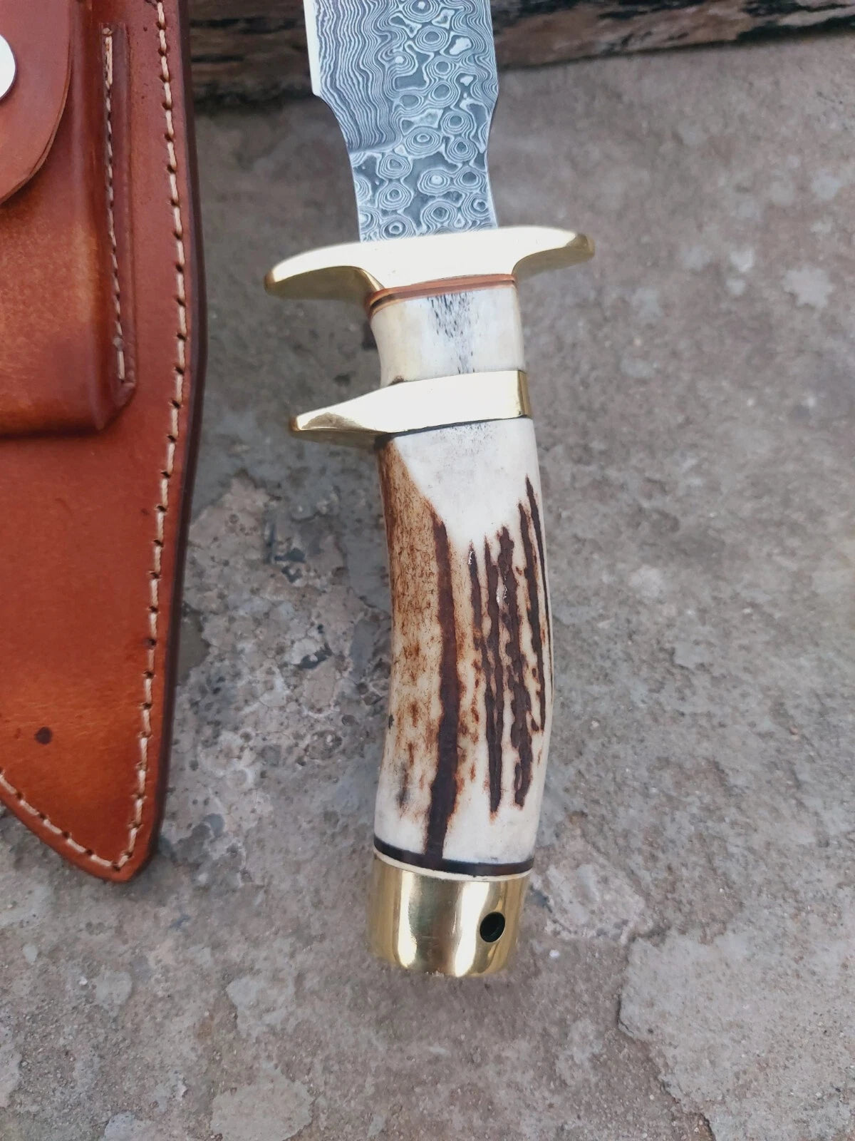 Stag antler handle Damascus steel subhilt knife built for strength and beauty. The hand-forged blade shows bold Damascus layers, while the leather sheath ensures safe storage. A perfect gift for collectors or tool for hunters.