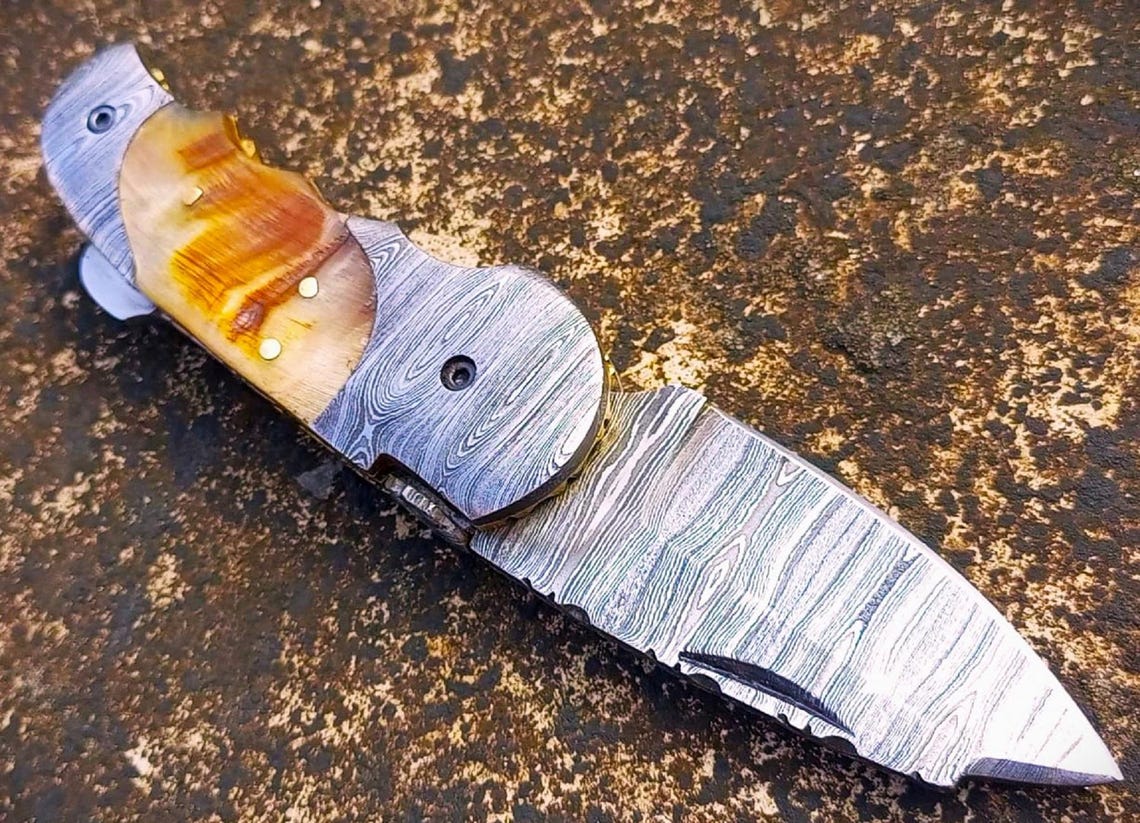 Handmade Damascus folding knife for outdoor camping and everyday carry use.