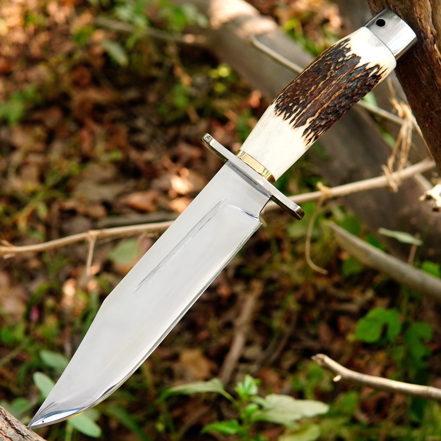 Handmade knife paired with a durable black leather sheath for safe carry.