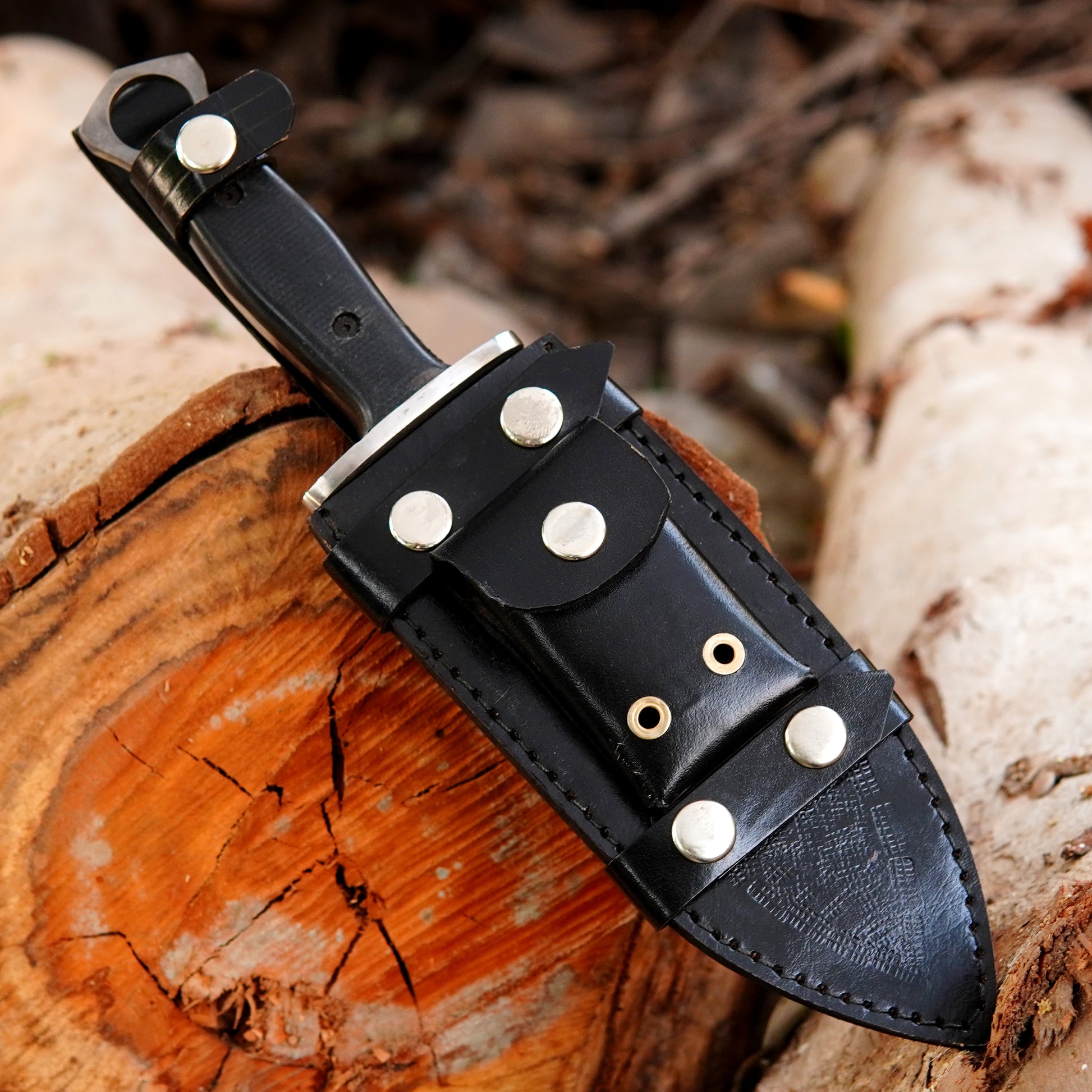 Carbon steel Bowie knife with wide blade and strong tactical design for heavy duty tasks.