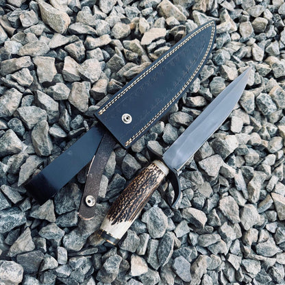 Full tang handmade Bowie knife with 5160 spring steel blade and classic stag handle design, photographed on rugged stone background. Perfect for hunting, camping, and display.