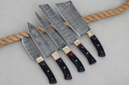 This resin handle chef knife set is crafted from Damascus steel with strong full tang blades. Handmade for quality and balance, it is both a functional kitchen tool and a collectible set for chefs.