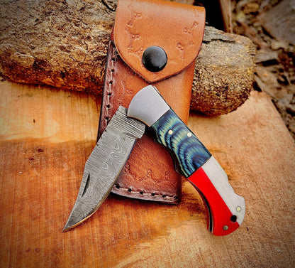 Damascus folding pocket knife closed position showing patriotic handle style and compact carry design.