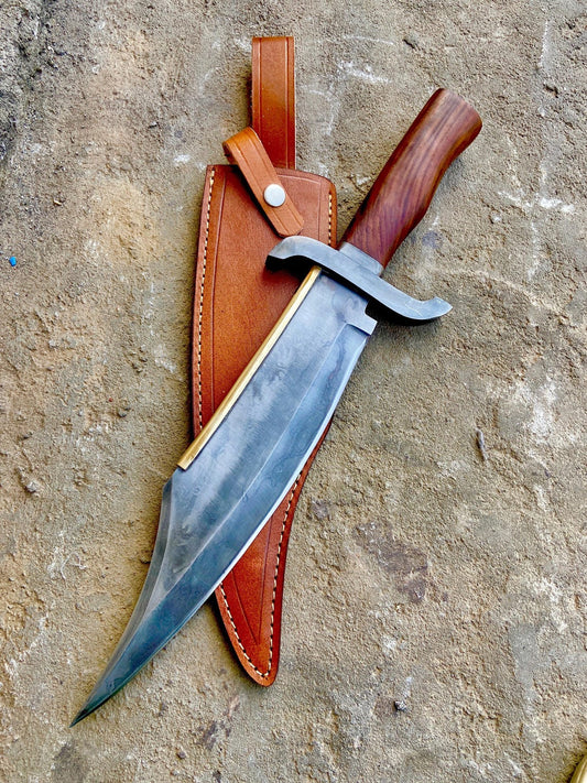 Full view of 17-inch Alamo Musso bowie knife with acid-washed blade and wooden handle resting on premium leather sheath.