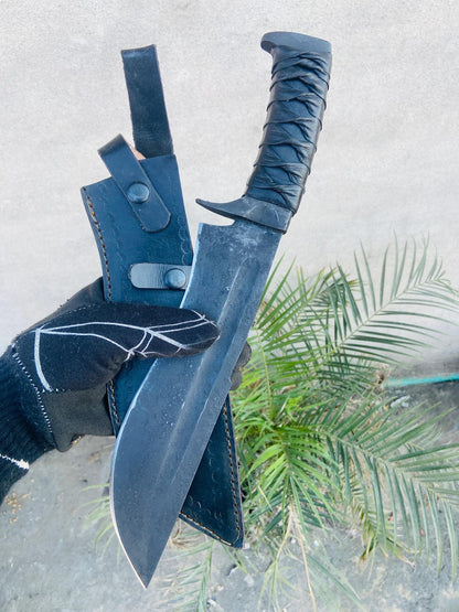 Spine and fuller detail on black forged bowie blade, leather wrap providing secure ergonomic hold.