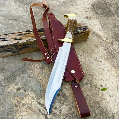 Close-up of the stag handle texture and brass guard on the handmade Bowie knife.