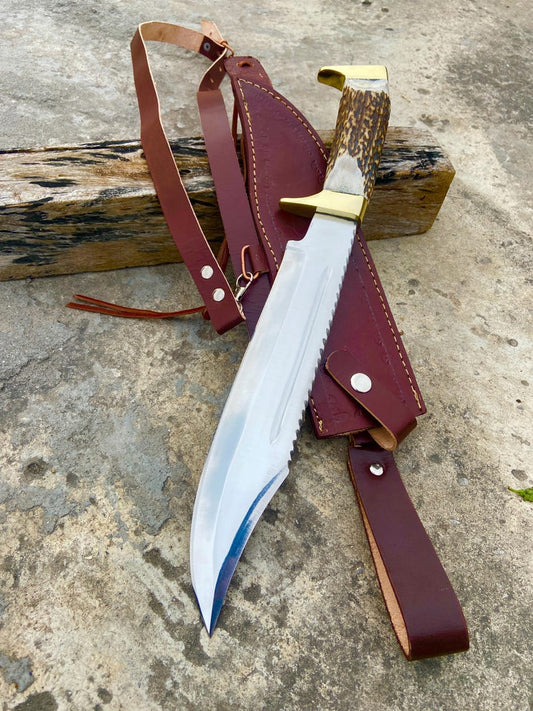 Full view of Bazil Blades handmade Bowie knife with stag handle and brown leather shoulder sheath.
