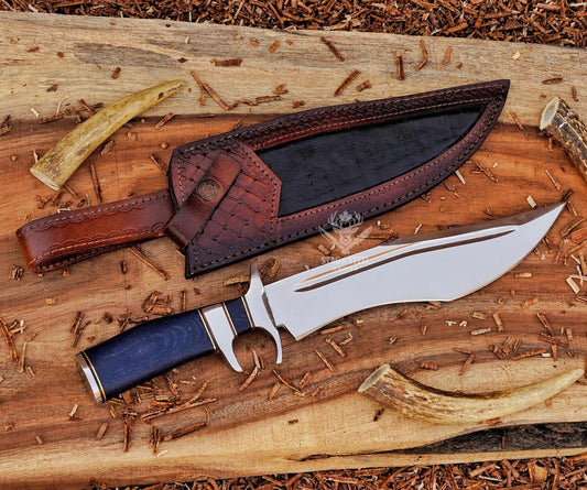 Handmade D2 steel bowie knife with blue Micarta handle and leather sheath displayed on wooden background.