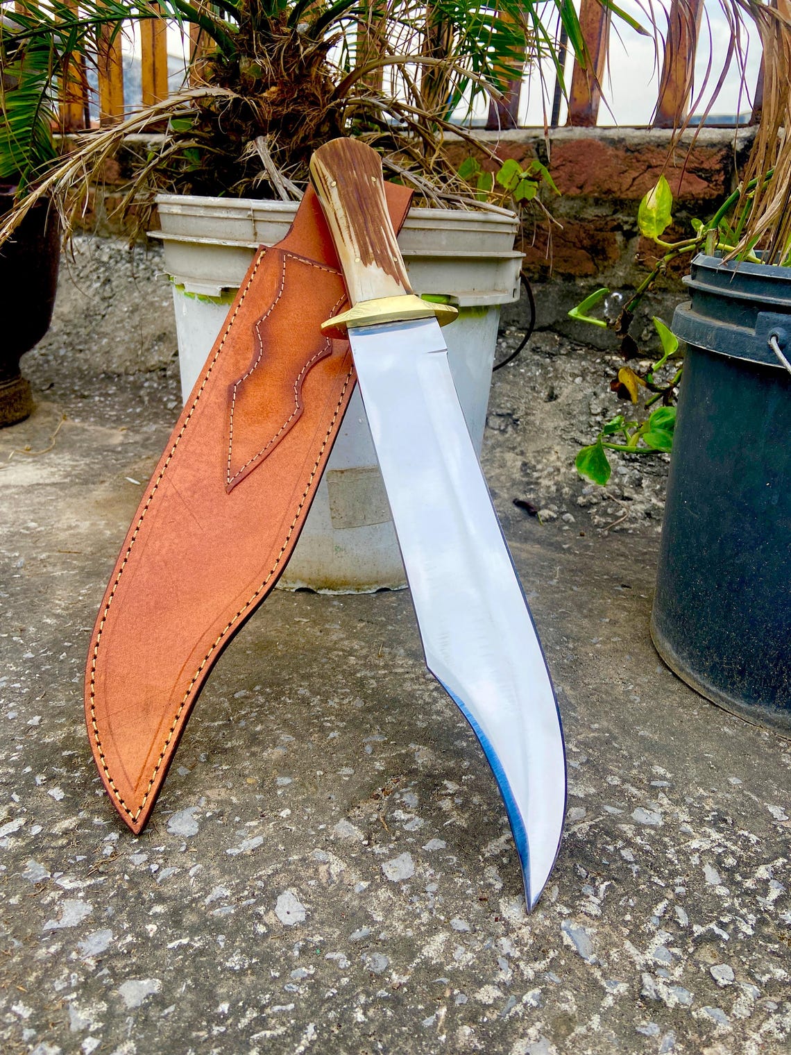 Full knife and sheath set displayed outdoors for hunting and gift use.