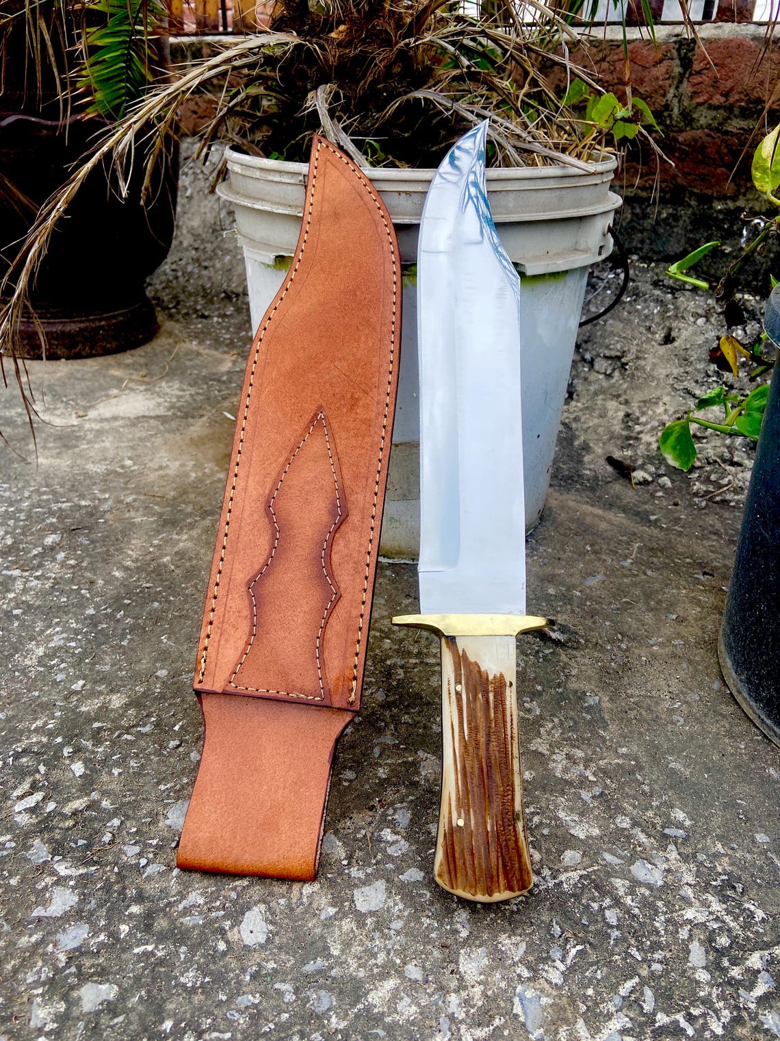Closeup of stag handle and leather sheath stitching and design work.