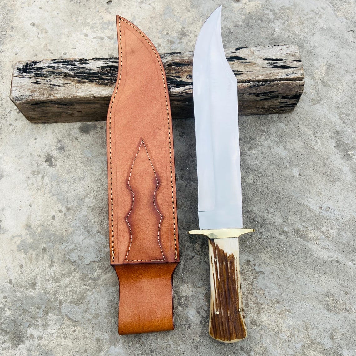 Side angle showing entire bowie blade profile and stag handle grip texture.
