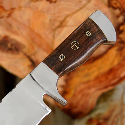 Full tang bowie knife displayed on natural background emphasizing strong construction and heavy duty cutting power. The long blade shape supports slicing chopping and outdoor utility work while the handle ensures comfort and stability. A practical companion for wilderness adventures bushcraft tasks and collectors who value handmade quality