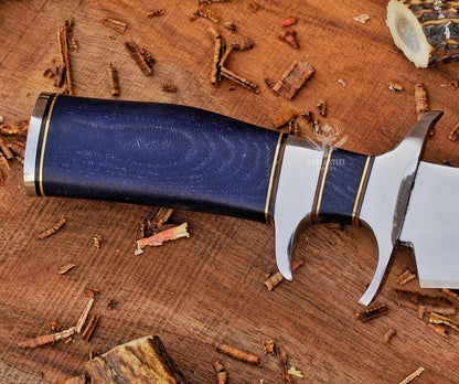 Leather sheath with artificial skin panel and handmade bowie knife laid on display.