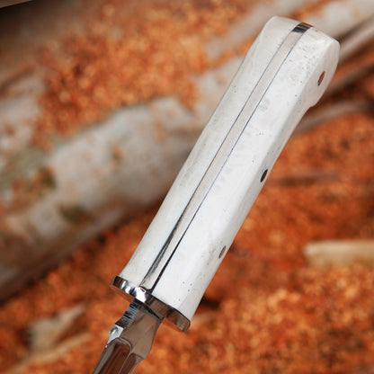 Fixed blade bowie knife displayed with leather sheath resting on wooden surface showing clean blade finish and handcrafted detailing ideal for outdoor enthusiasts and gift buyers searching for premium handmade knives.