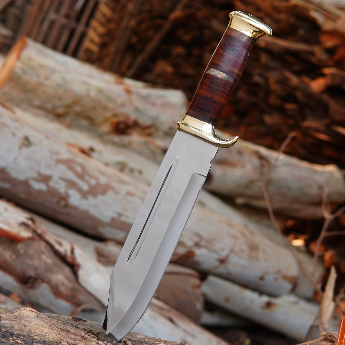 Full display of the handmade hunting knife and sheath together, placed on natural wood for an authentic outdoor feel. The polished blade, stacked handle, and brass accents create a strong and elegant appearance. Built for durability and outdoor reliability, this knife is ideal for camping trips, hunting adventures, or as a memorable gift for men who appreciate craftsmanship and quality tools.