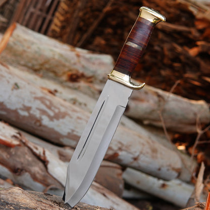 Full display of the handmade hunting knife and sheath together, placed on natural wood for an authentic outdoor feel. The polished blade, stacked handle, and brass accents create a strong and elegant appearance. Built for durability and outdoor reliability, this knife is ideal for camping trips, hunting adventures, or as a memorable gift for men who appreciate craftsmanship and quality tools.
