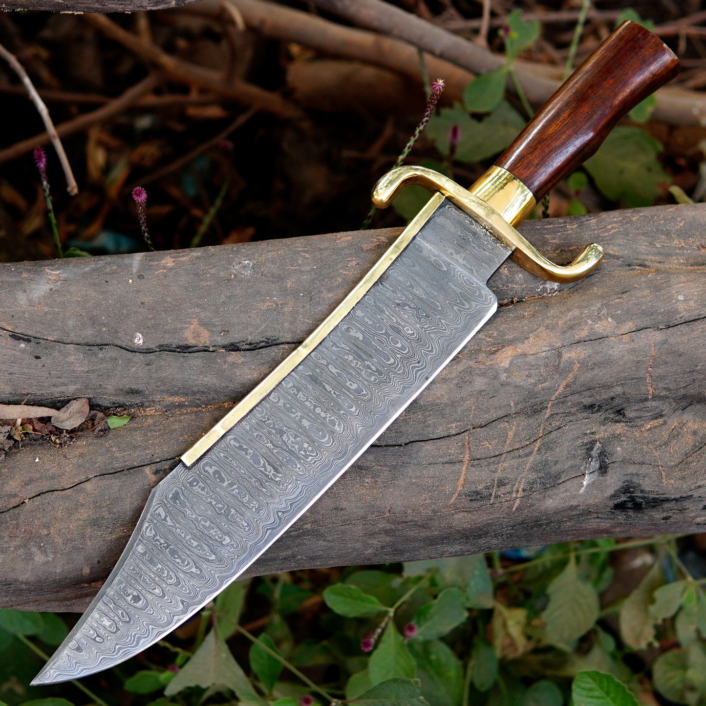 Full length handmade Damascus bowie knife displayed on natural background showing blade shape, handle design, and overall proportions. The image helps customers clearly understand product size, design balance, and intended outdoor use such as camping or collection display.