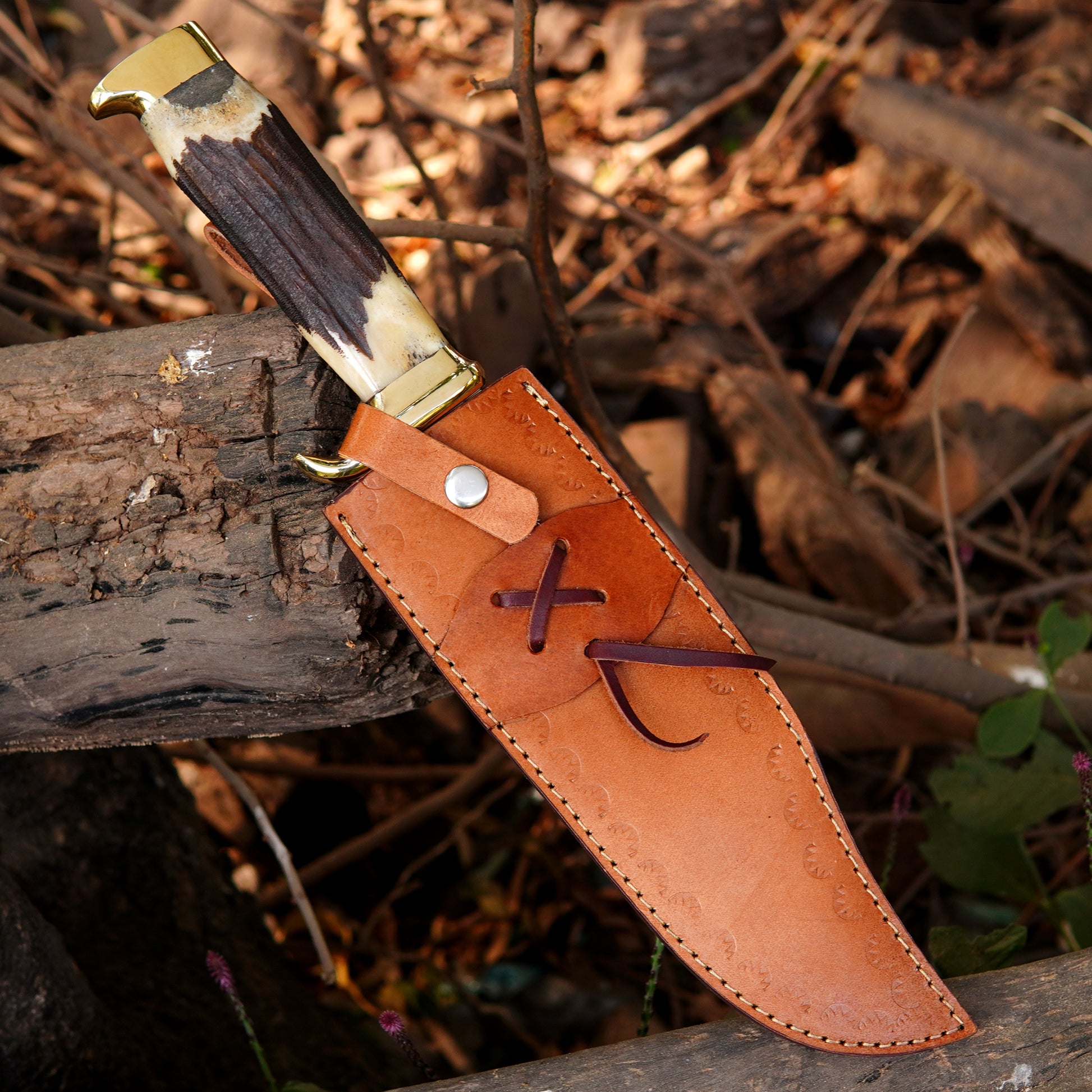 Handmade outdoor knife presented in a rustic setting highlighting craftsmanship and balance.