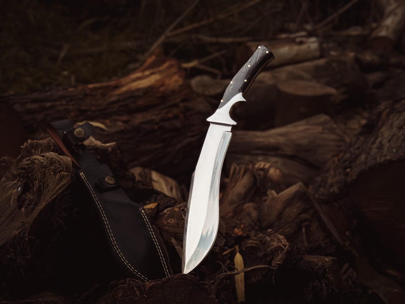 Close-up of the buffalo horn handle with brass pins and ergonomic finger groove.