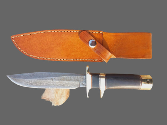Damascus steel hunting knife featuring a polished patterned blade, sturdy micarta handle, and brass fittings. The knife includes a hand-stitched leather sheath, making it a reliable choice for outdoor use, survival tasks, or as part of a custom knife collection.