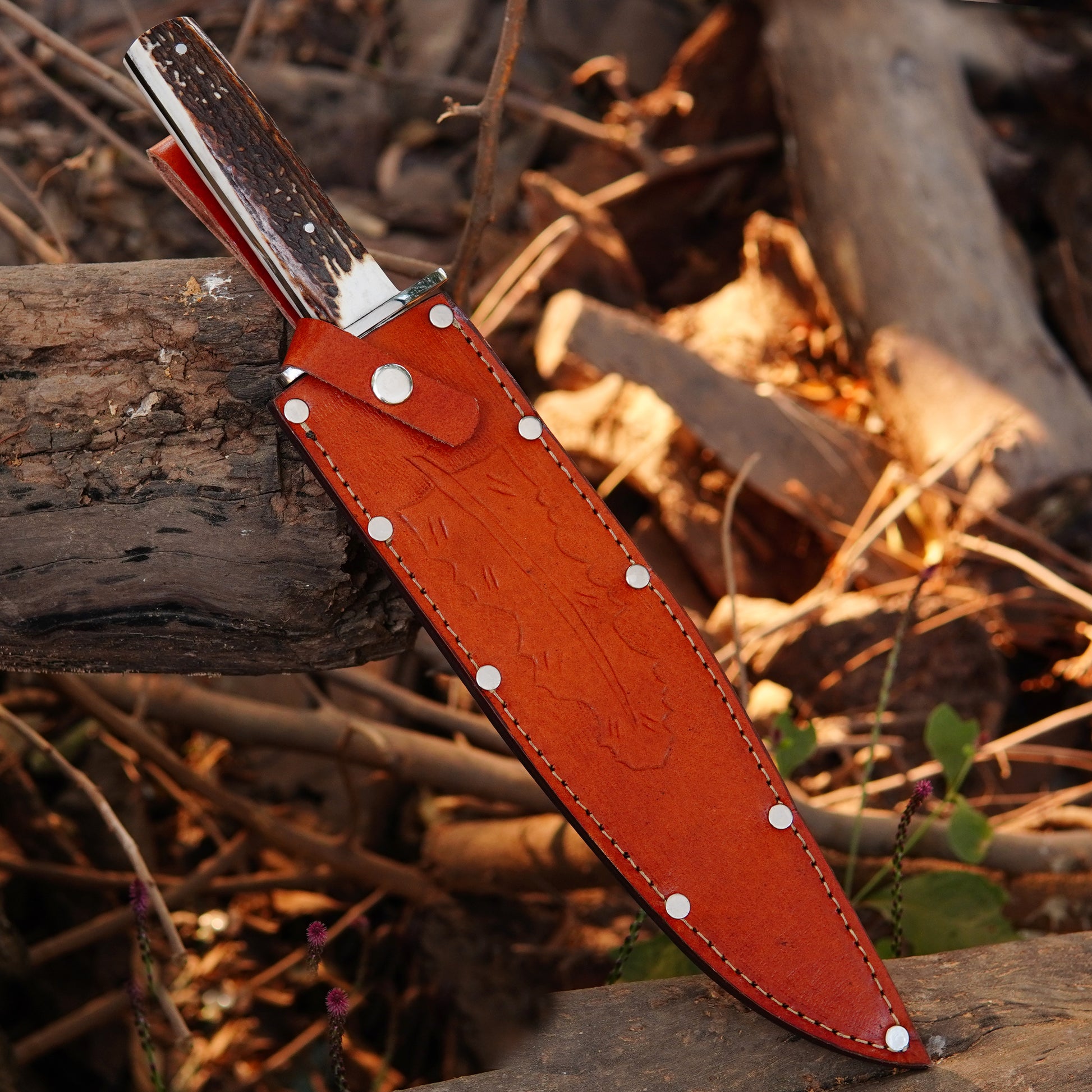 Premium Bowie knife with brown pure leather sheath featuring reinforced rivets and stitching.