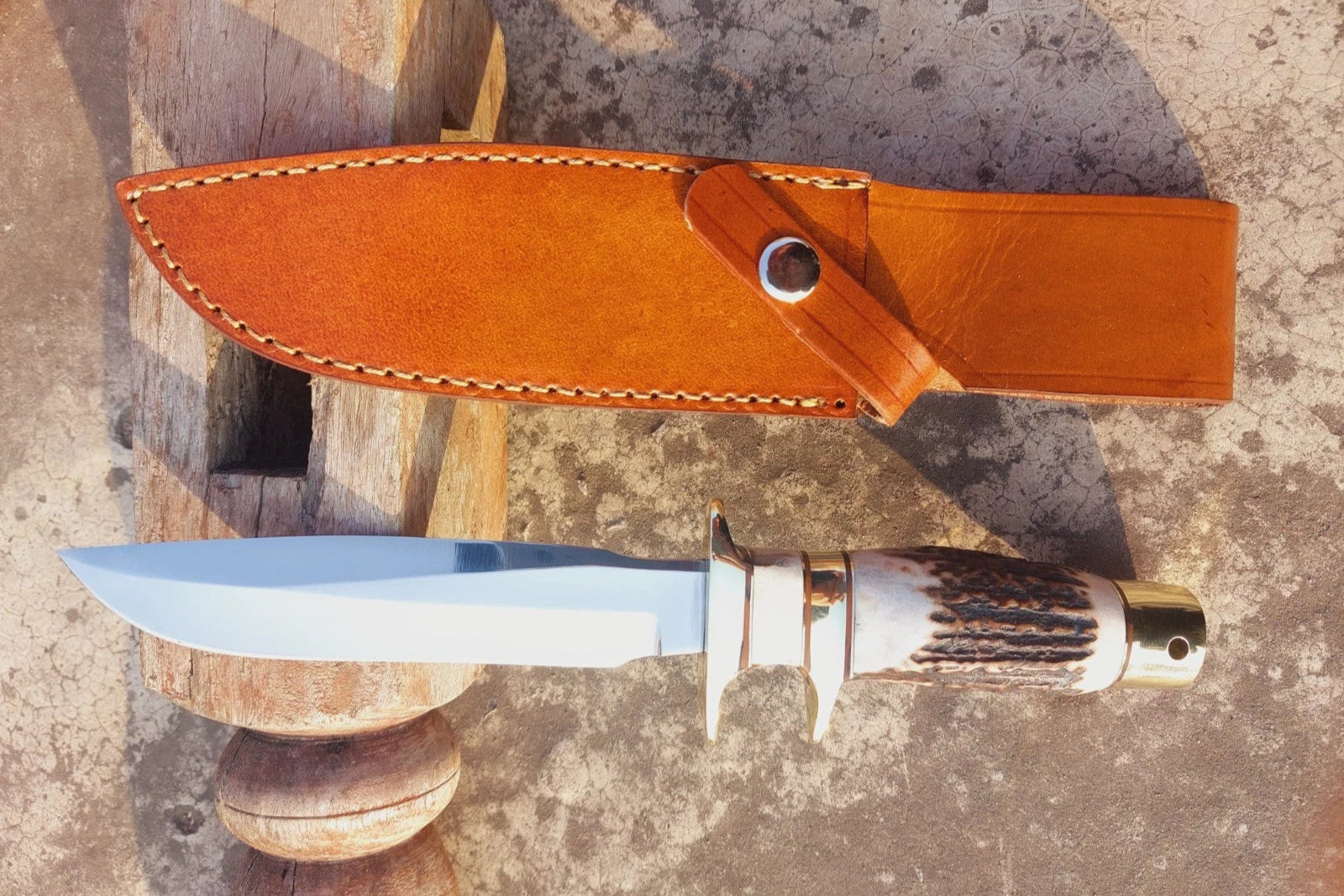 Handmade hunting knife crafted from carbon steel with a mirror-polished blade, natural material handle, and brass guard for balance. Comes with a hand-stitched leather sheath for protection and portability. A strong, sharp, and elegant knife for outdoor use, hunting, camping, or as a collectible piece.