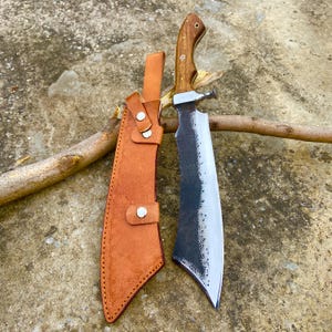 High-quality outdoor Bowie machete with carbon steel blade and custom leather sheath.