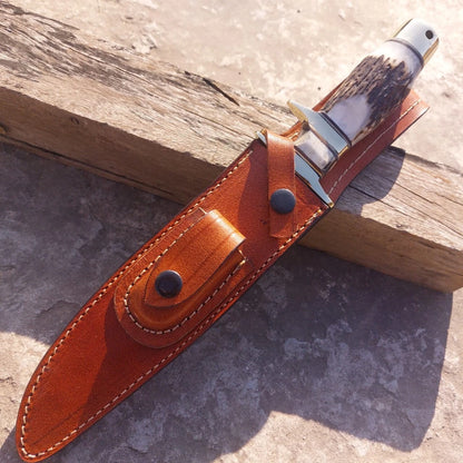 Outdoor handmade hunting knife with carbon steel blade, mirror shine finish, and stag handle. Features brass guard and butt cap for durability. Includes a genuine stitched leather sheath, making it perfect for use in the field or as part of a collection.
