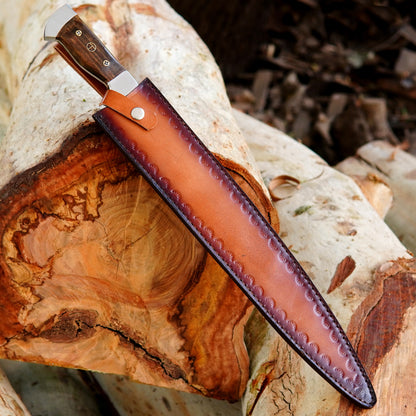 Outdoor survival knife resting beside its stitched leather sheath showing secure fit and protective design. The warm brown leather complements the steel blade and wood handle creating a rugged yet premium look. Suitable for belt carry during hiking camping or hunting trips this knife is crafted for daily field use and long lasting performance