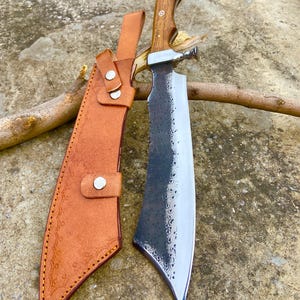 Detailed shot showing rosewood handle, guard, and tang of handmade carbon steel knife.