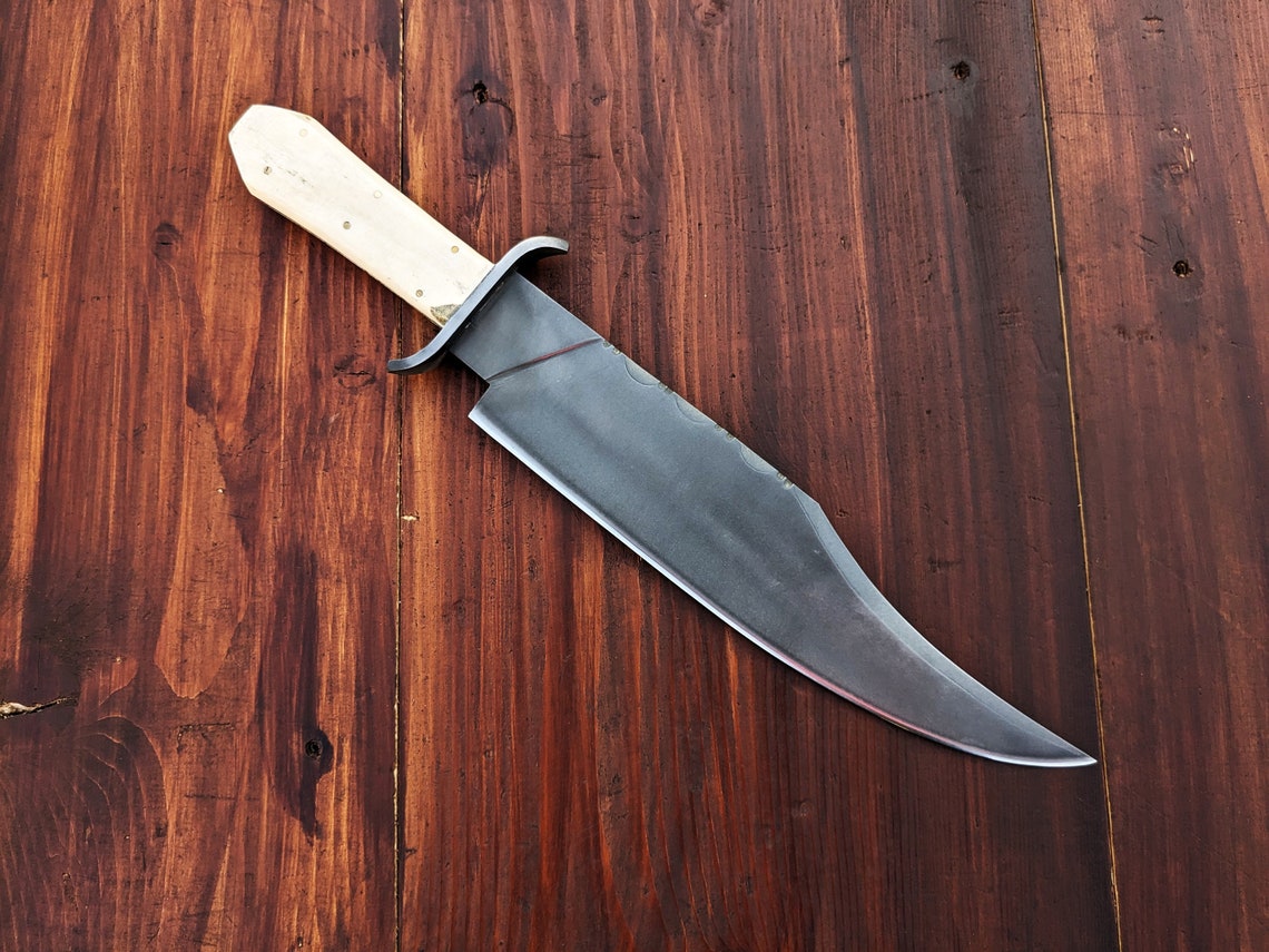 Custom handmade carbon steel Bowie knife with full tang construction, double guard, and natural camel bone handle, built for durability, strength, and outdoor performance.