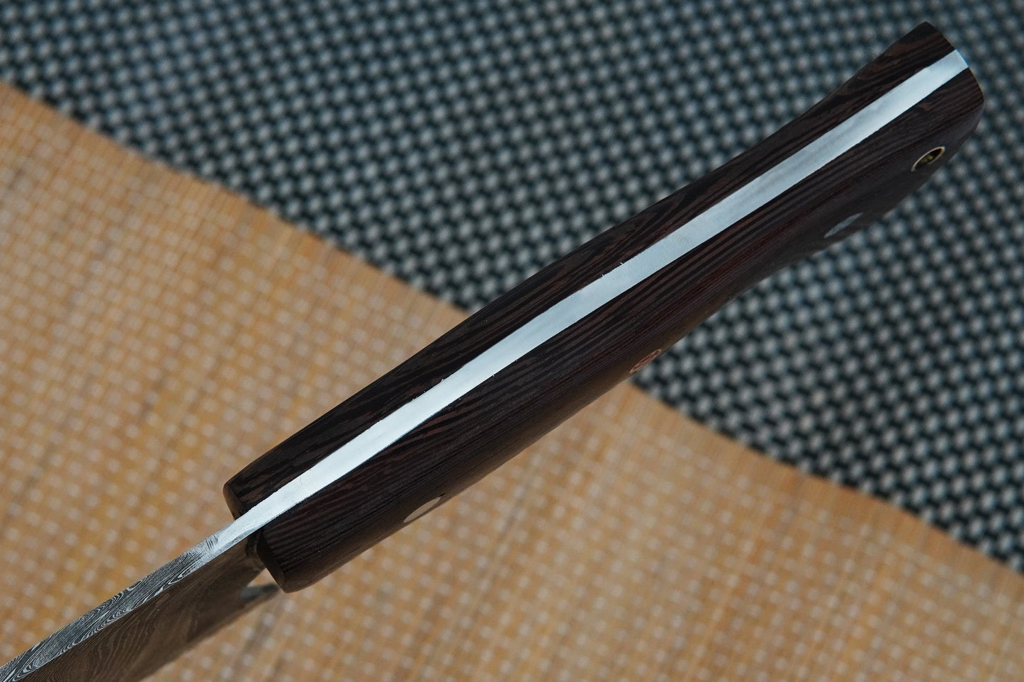 A chef cleaver knife crafted from Damascus steel with a full tang construction and handmade wenge wood handle. Designed for everyday cooking or outdoor BBQ, this knife is sharp, durable, and customisable with free engraving.