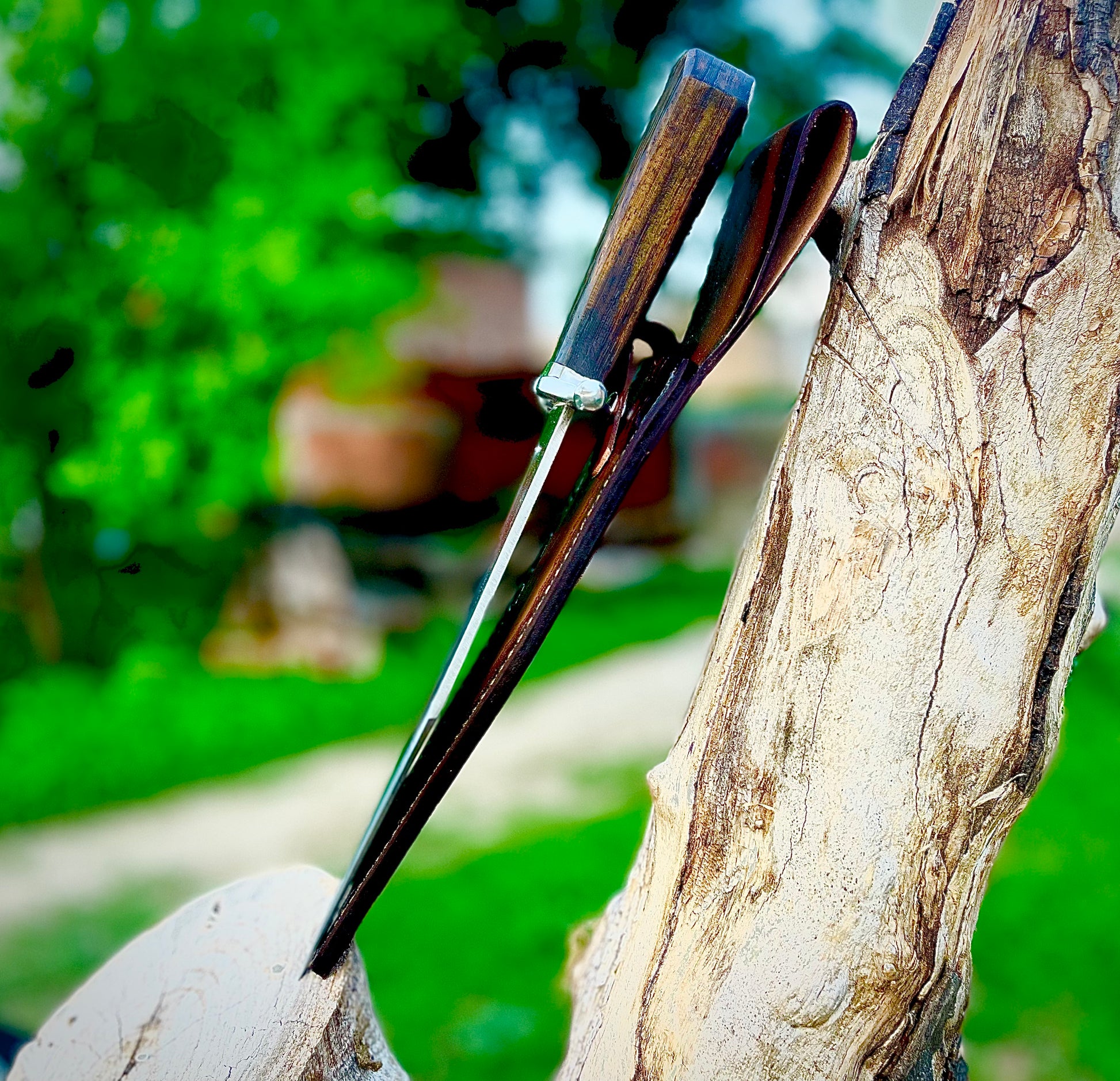 Forged Bowie knife with an authentic 1095 carbon steel blade, natural wenge wood grip, and a hand-stitched leather sheath that enhances style and function.