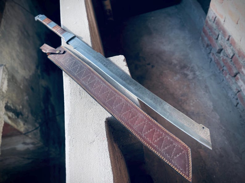 Close-up of Viking sword wooden handle with Damascus steel patterns.