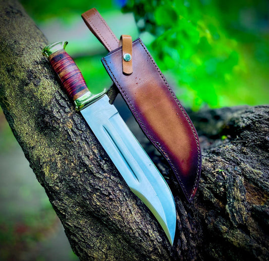 Crocodile Dundee style handmade Bowie knife with polished carbon steel blade, stacked leather handle, and durable stitched brown leather sheath. The knife combines classic design with high-quality materials, making it perfect for outdoor use, camping, and display. A true collector’s item for knife enthusiasts who appreciate traditional craftsmanship and long-lasting performance.