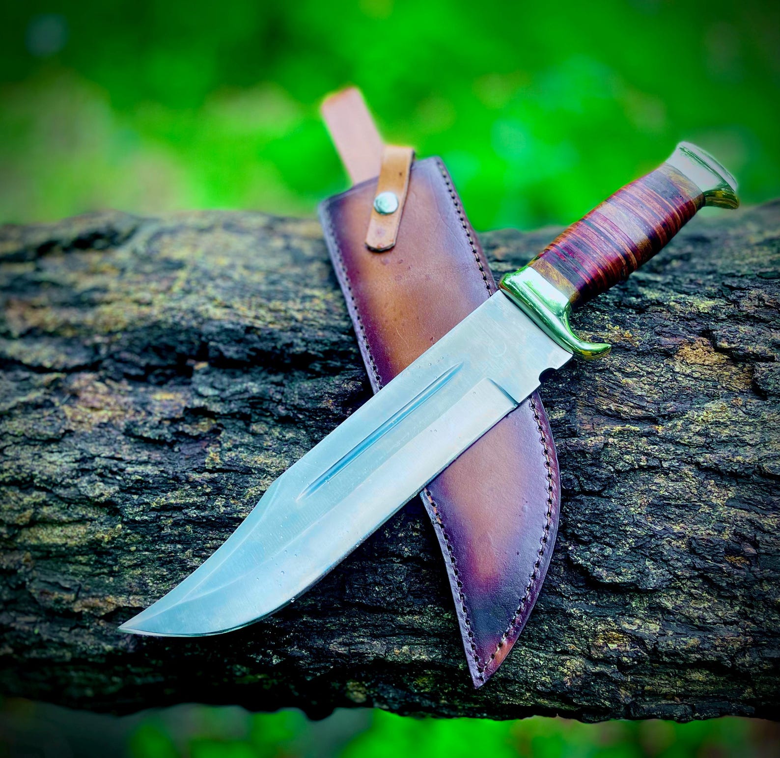 Collector edition handmade Crocodile Dundee Bowie knife crafted from carbon steel with stacked leather handle and protective leather sheath. This legendary knife design is admired worldwide for its durability, unique look, and practical outdoor use. Perfect as a gift, display piece, or reliable tool for hunting and survival. Each knife highlights handmade artistry and authentic Crocodile Dundee style.