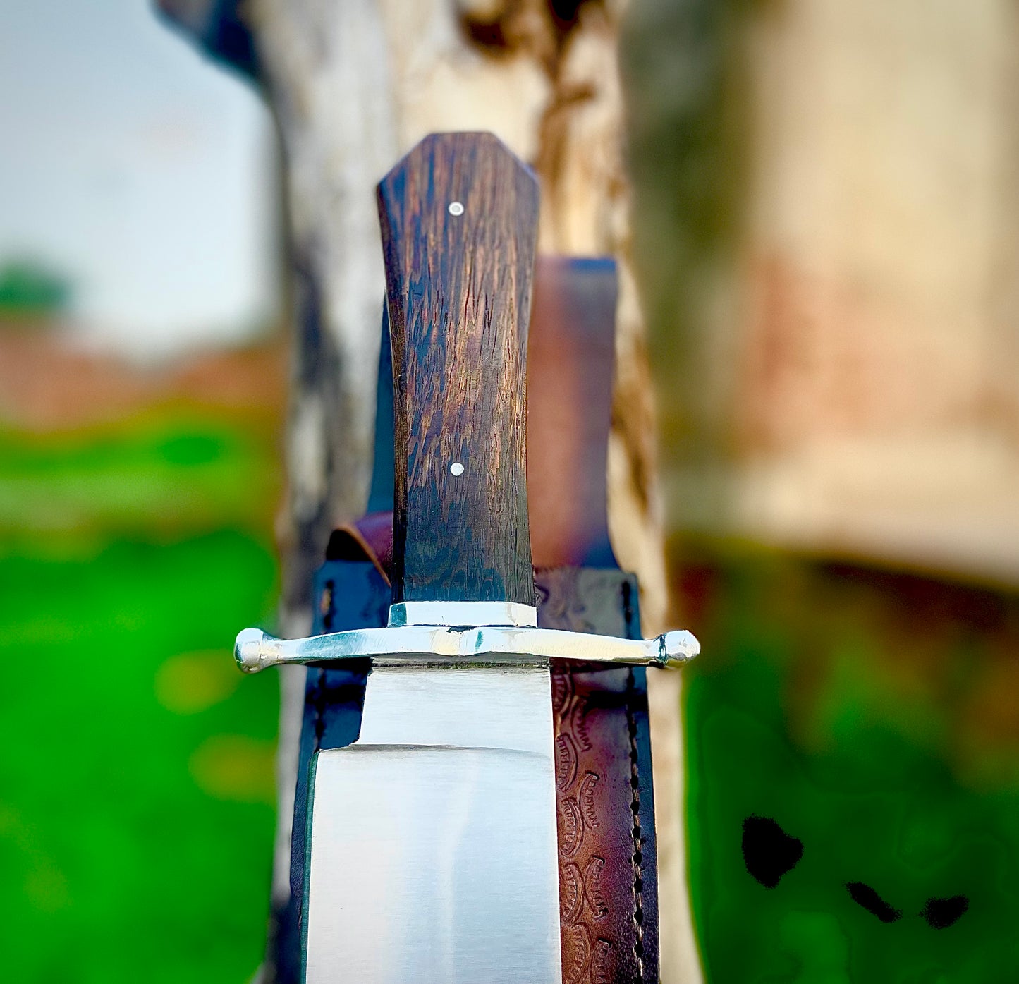 Custom Bowie knife designed for collectors, forged from 1095 carbon steel, highlighted with a smooth wenge wood handle and durable leather sheath.