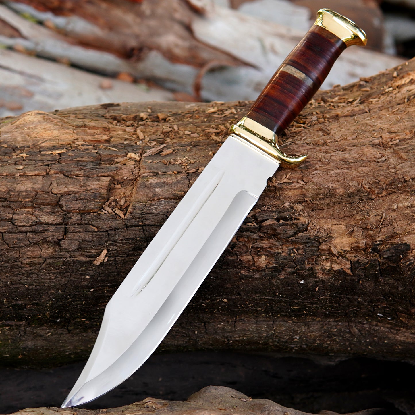 Close-up view of the custom Bowie knife blade showing its clean satin finish and deep fuller groove along the center. The blade is carefully crafted for strength and durability, offering a balanced weight and smooth cutting performance. The strong construction ensures long-term reliability for outdoor tasks. This knife comes with a handcrafted pure leather sheath, making it suitable for collectors, outdoorsmen, and those looking for a meaningful handmade gift for men.