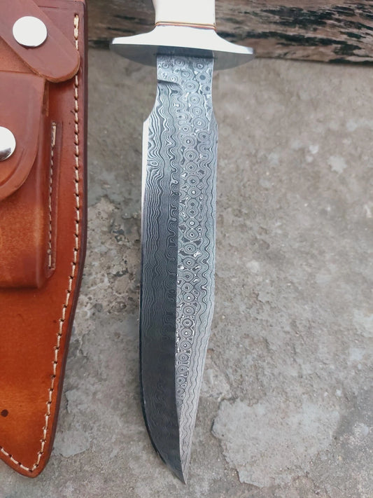 Custom Damascus steel fixed blade knife with detailed forging patterns, natural bone handle, and polished fittings. Includes a high-quality hand-stitched leather sheath for protection. Ideal for outdoor use, survival gear, or as a collectible blade.
