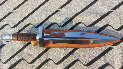 Double-edge dagger knife displayed with brown leather sheath.