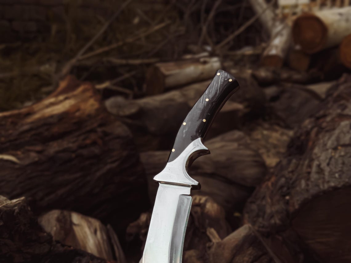 Angled close-up of the guard and handle junction, highlighting craftsmanship.