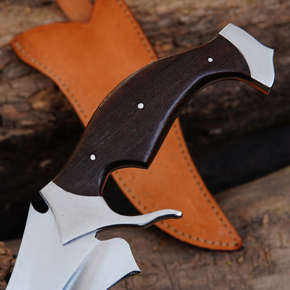 Full tang curved bowie knife shown with leather sheath in outdoor lighting, emphasizing durability and strong construction. The polished blade reflects light naturally while the sheath adds protection and portability, making the knife suitable for camping, survival activities, and display purposes.