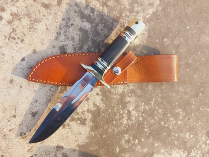 Handmade hunting knife with micarta handle, mirror-polished blade, and brass guard. The knife includes a stitched leather sheath for safe storage, making it ideal for hunters, outdoor adventurers, and collectors who value strength, durability, and craftsmanship.
