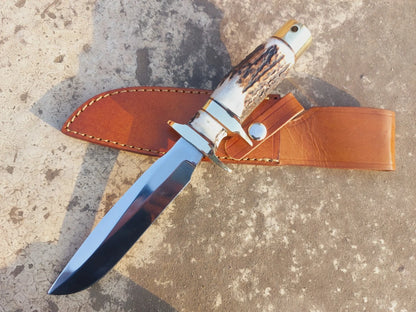Handmade subhilt hunting knife with carbon steel blade, polished finish, and natural handle. Brass guard and butt cap add balance and durability. Comes with a stitched leather sheath for safe storage and easy carry.