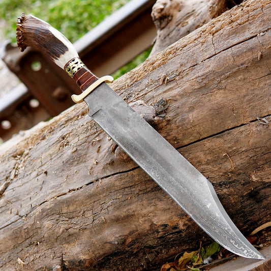 Close view of handmade bowie knife placed inside a brown leather sheath showing clean blade edge and natural handle material. This image represents outdoor usability, durable construction, and handcrafted finishing, ideal for search visibility related to camping knives, outdoor gear, and handmade gift ideas for men.