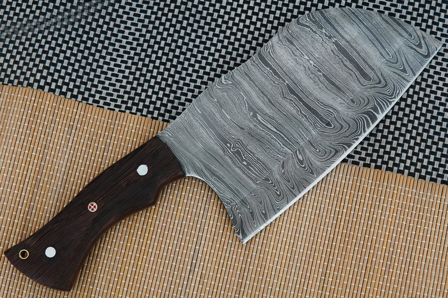 A Damascus cleaver knife handmade with a full tang blade and wenge wood handle. Built to last for meat cutting, BBQ, or outdoor cooking. Makes a great personalised gift with free engraving offered on blade or sheath.