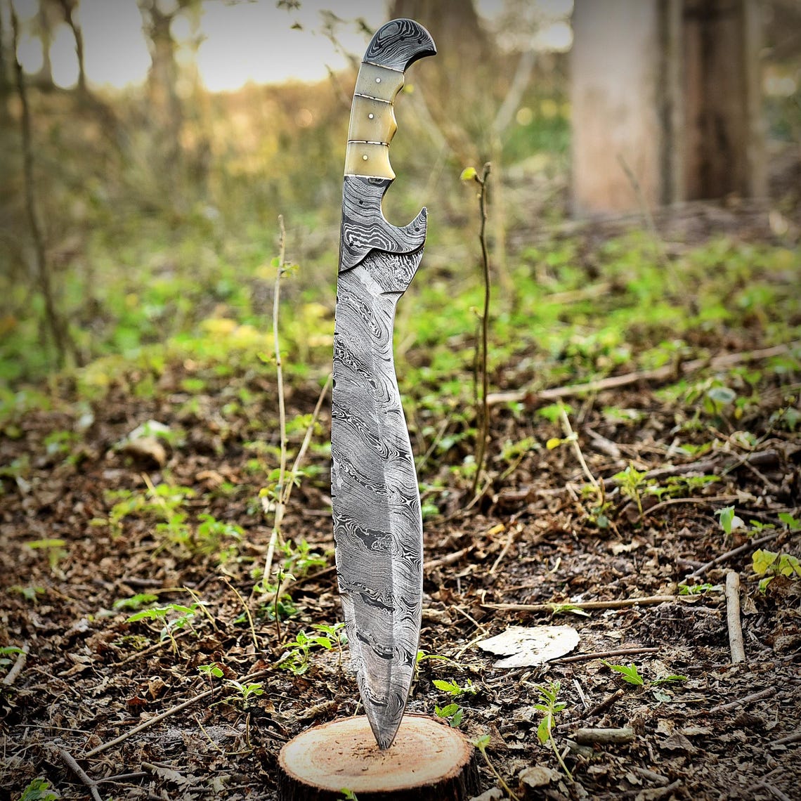 Handmade Damascus steel Kukri knife with full tang construction and polished camel bone handle, featuring a beautiful wave pattern along the blade. Perfect for survival, hunting, or outdoor use, this handcrafted Bowie-style Kukri offers power, balance, and premium craftsmanship for collectors and adventurers alike.