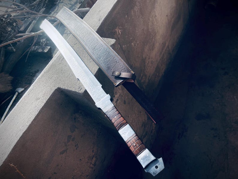 Handmade Damascus Viking sword resting in its leather sheath